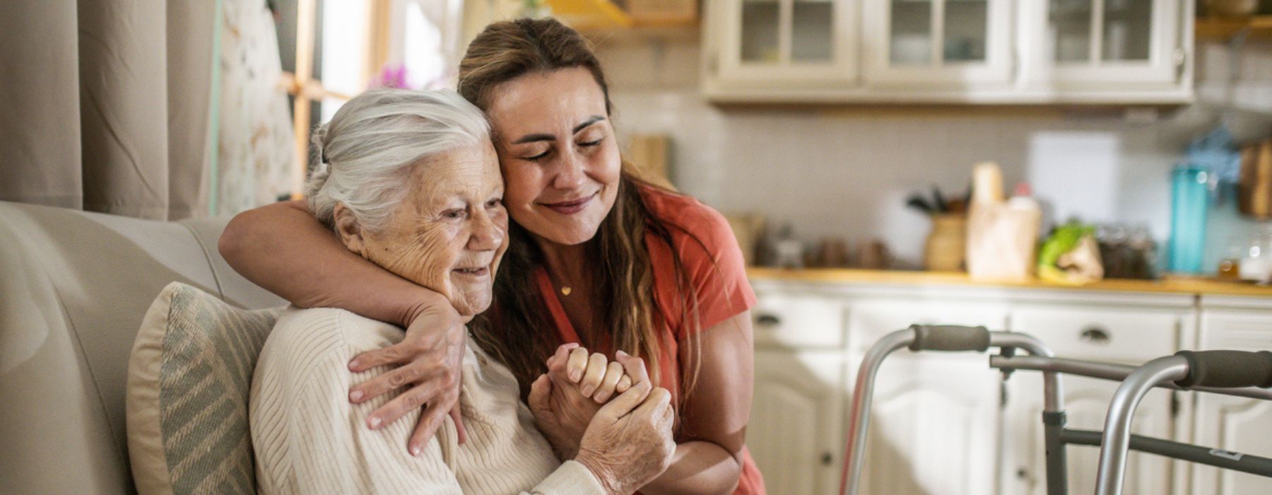 A caregiver hugging and supporting a senior woman at home, representing home care in Reynoldsburg