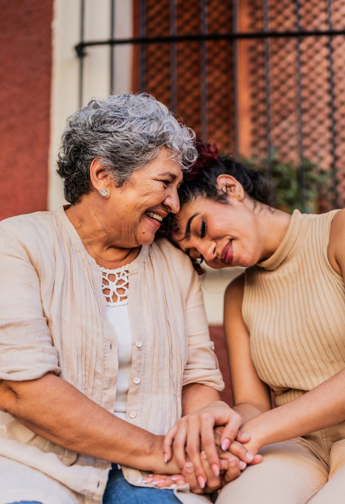 Caregiver holding hands with senior woman showing companionship in home care in West Chester, OH