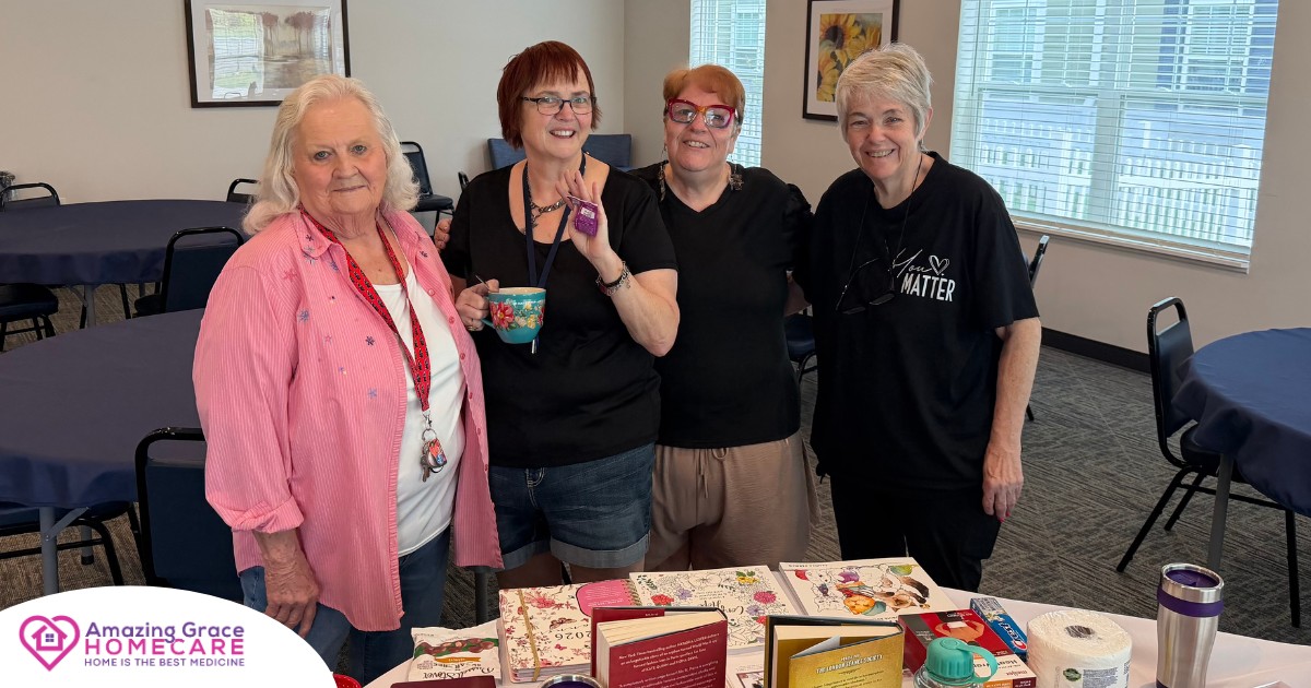 Four smiling women standing together behind a round table filled with assorted event prizes